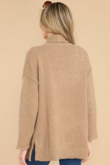 Back view of  this cardigan that features a folded collar, functional pockets, and side slits.