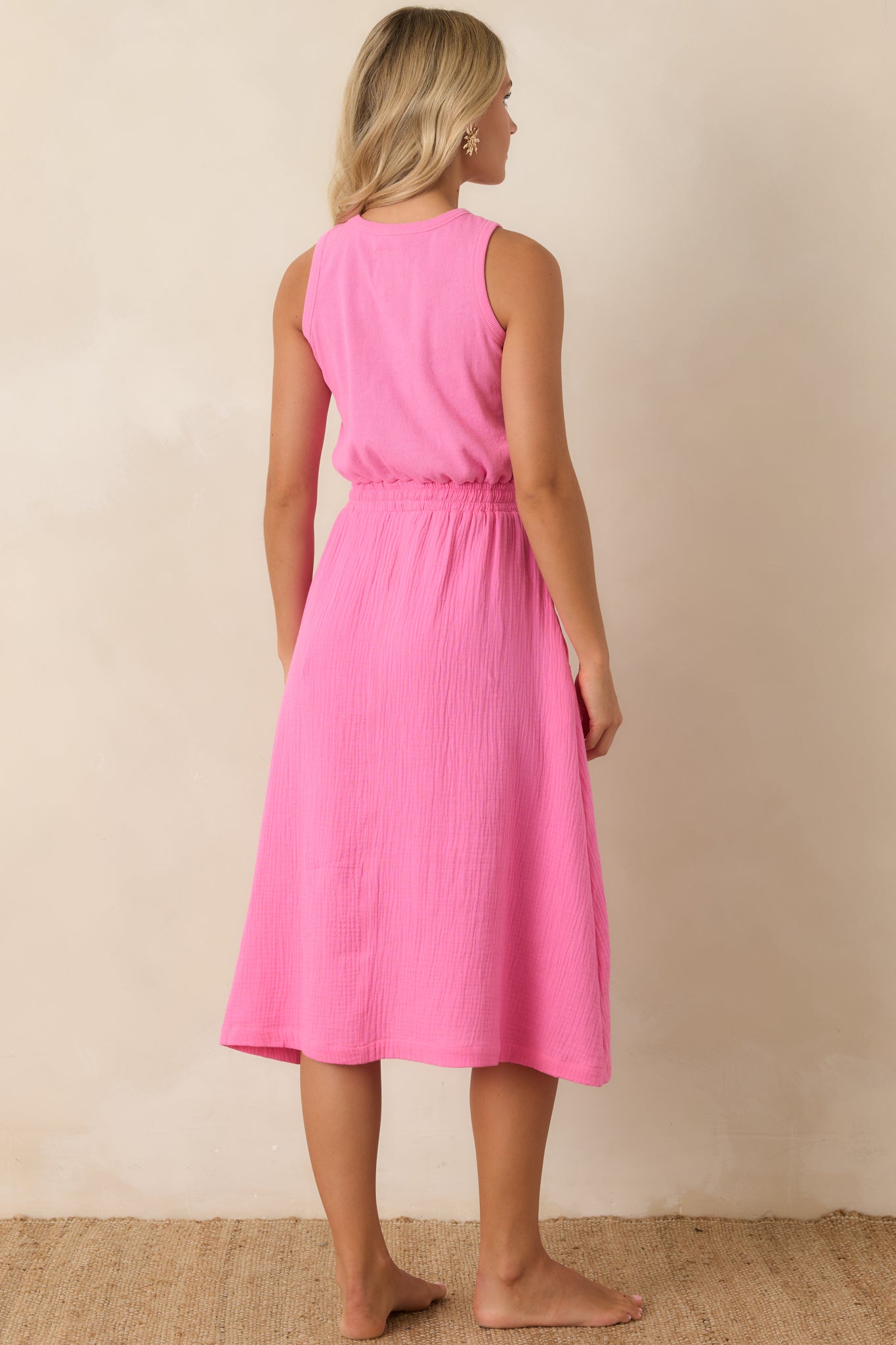Rear view of the sleeveless midi dress with a relaxed shape and gathered waist detail.