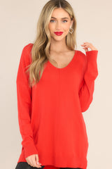 Front view of this sweater that features a v-neckline, center seam down the front, a high low hem, slits on the sides, and ribbed detailing on the cuffs and hem.