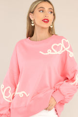 Front view of this sweatshirt that features a textured whimsical heart detailing.