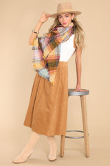 Full body view of this scarf that features a plaid pattern throughout with fringe sides.