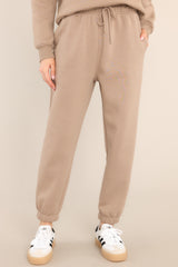 These toast colored joggers feature a self-tie drawstring waist, pockets, and cuffed elastic ankles.