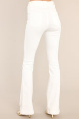 Back view of these jeans that feature flared legs, belt loops, and an elastic waistband.