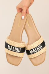 These tan and black sandals feature a strap across the top of the foot with the name of a tropical location.