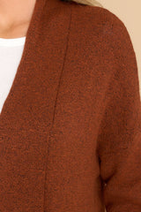 Close up view of this cardigan that features front pockets, an oversized cozy fit, and soft knit fabric.