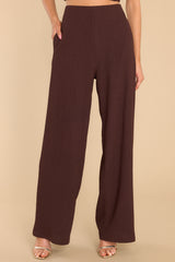 These brown pants feature a high rise, an elastic waistband, functional pockets, and a wide, flowy pant leg.