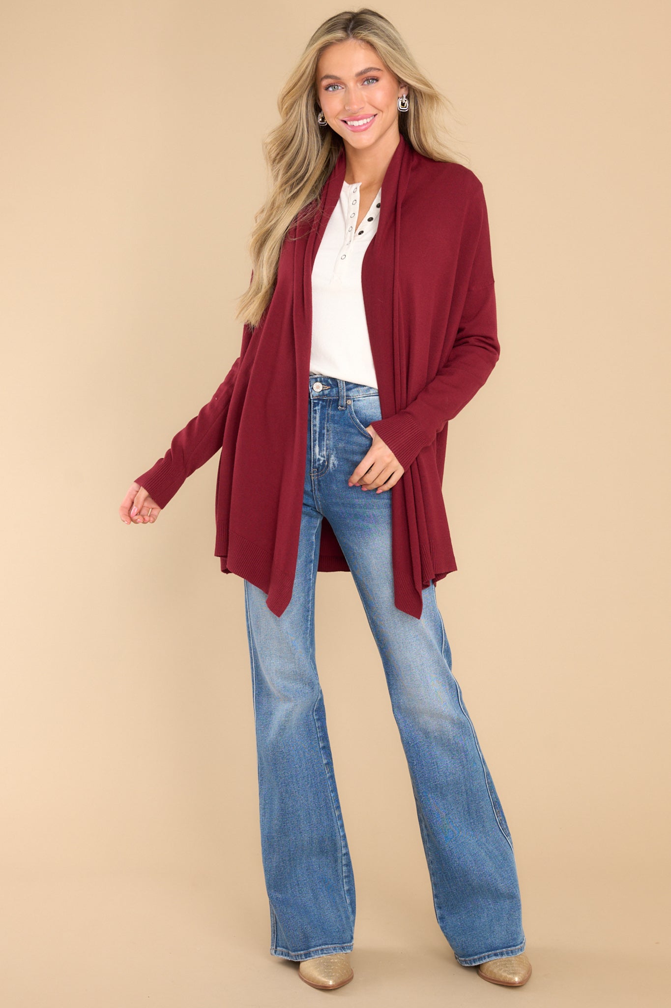 Full body view of this cardigan that features a large slouchy folded collar, ribbed fitted cuffs, and ribbed hemline details.