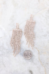 Clear gold dangle earrings compared to quarter for actual size. Earrings measure 3.5