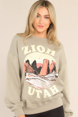 Front view of this sweatshirt that features a ribbed crew neckline, dropped shoulders, a Zion graphic, ribbed cuffed long sleeves, and a ribbed hemline.