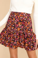 This burgundy skirt features a high waist-line, pleats, and a back zipper closure.