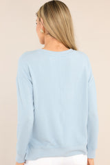 Back view of this top that features a ribbed crew neckline, an exposed seam down the middle, ribbed cuffed long sleeves, and a ribbed split hemline.