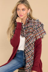 Front view of this plaid knit scarf that features a frayed edge design.