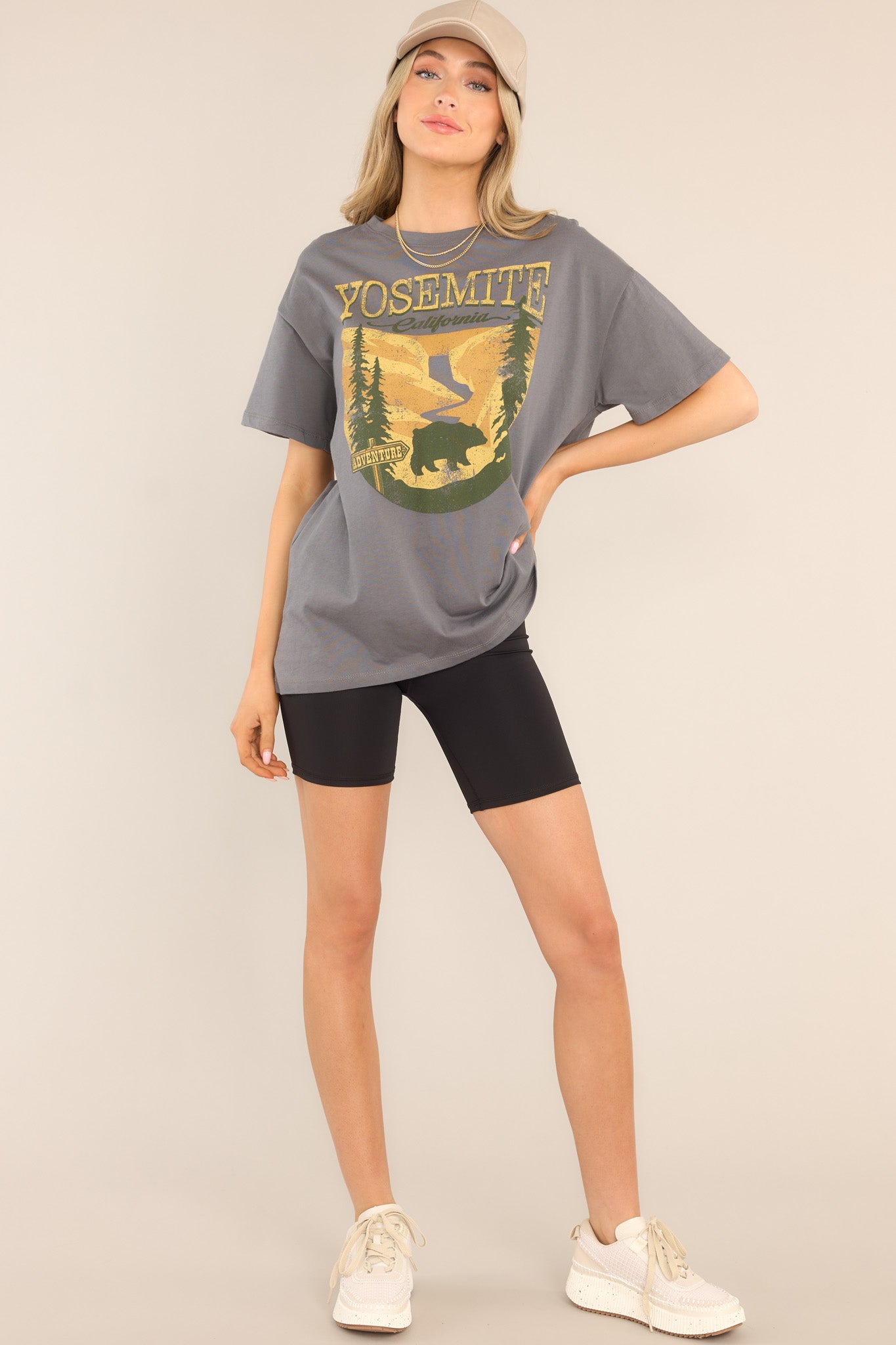 This grey top features a crew neckline, dropped shoulders, a mountain graphic, and short sleeves.