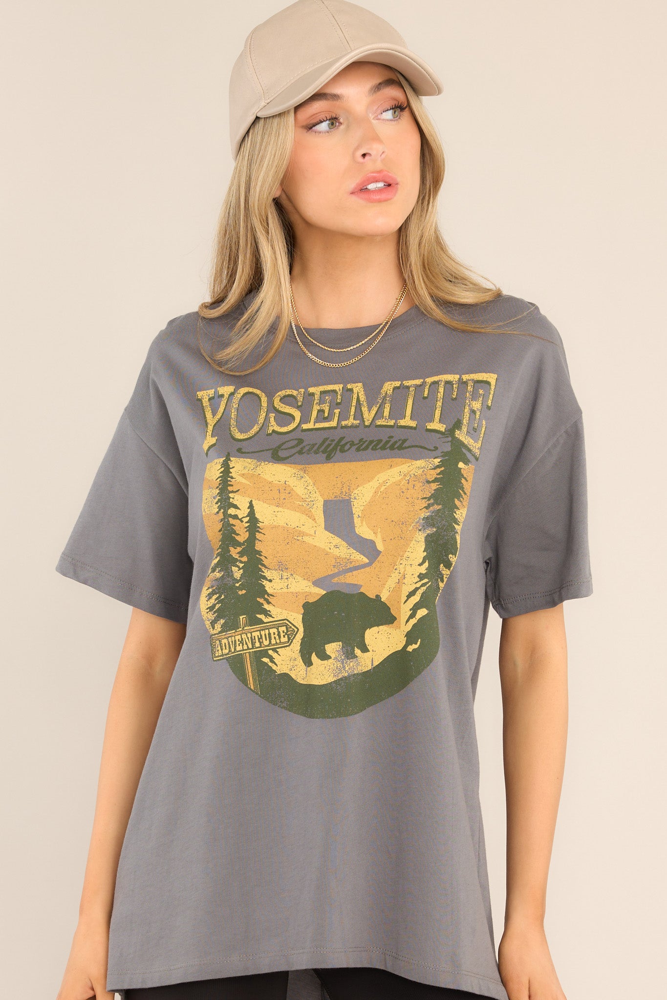 Front view of this top that features a crew neckline, dropped shoulders, a mountain graphic, and short sleeves.