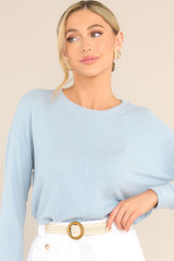 Front view of this top that features a ribbed crew neckline, an exposed seam down the middle, ribbed cuffed long sleeves, and a ribbed split hemline.