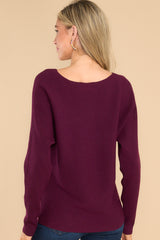 Back view of this sweater that features a round neckline and a soft stretchy material.