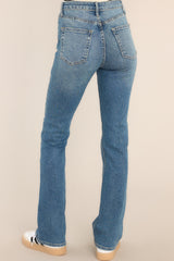 Relaxed back view of Medium Wash Stretch Straight Jeans that feature functional pockets and a standard zipper-button closure.