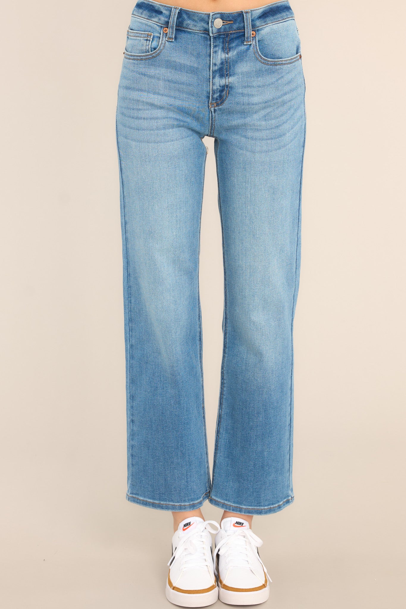 Front view of these jeans that feature a high waist design, a zipper and button closure, functional belt loops and pockets, and a straight leg.