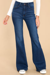 Full view of these jeans that feature a high waist, belt loops, front and back pockets, and a hemmed and flared bottom.