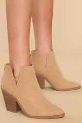 Full view of these booties that feature a pointed toe, a stacked heel, and a slit on the ankle.
