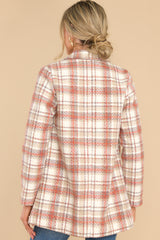 Back view of this coat that features a collared neckline, double breasted buttons on the front, pockets at the waist, and is fitted when buttoned.