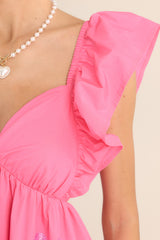 Close up view of this dress that features a sweetheart neckline and flutter sleeves.