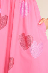 Close up view of this dress that features rhinestone heart detailing and functional pockets.