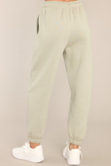 Back view of these joggers that feature a self-tie drawstring waist, pockets, and cuffed elastic ankles.