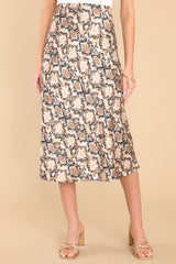 This taupe snake print skirt features a high waist design, an elastic waistband, and a satin-like feel. 