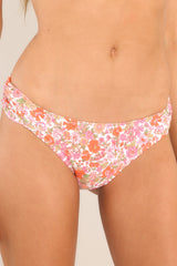 These pink floral bikini bottoms feature a low rise design, cinched hip detailing, and a slightly cheeky backside. 