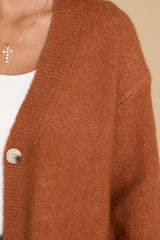 Close up view of this cardigan that features a v-neckline and functional buttons down the front.