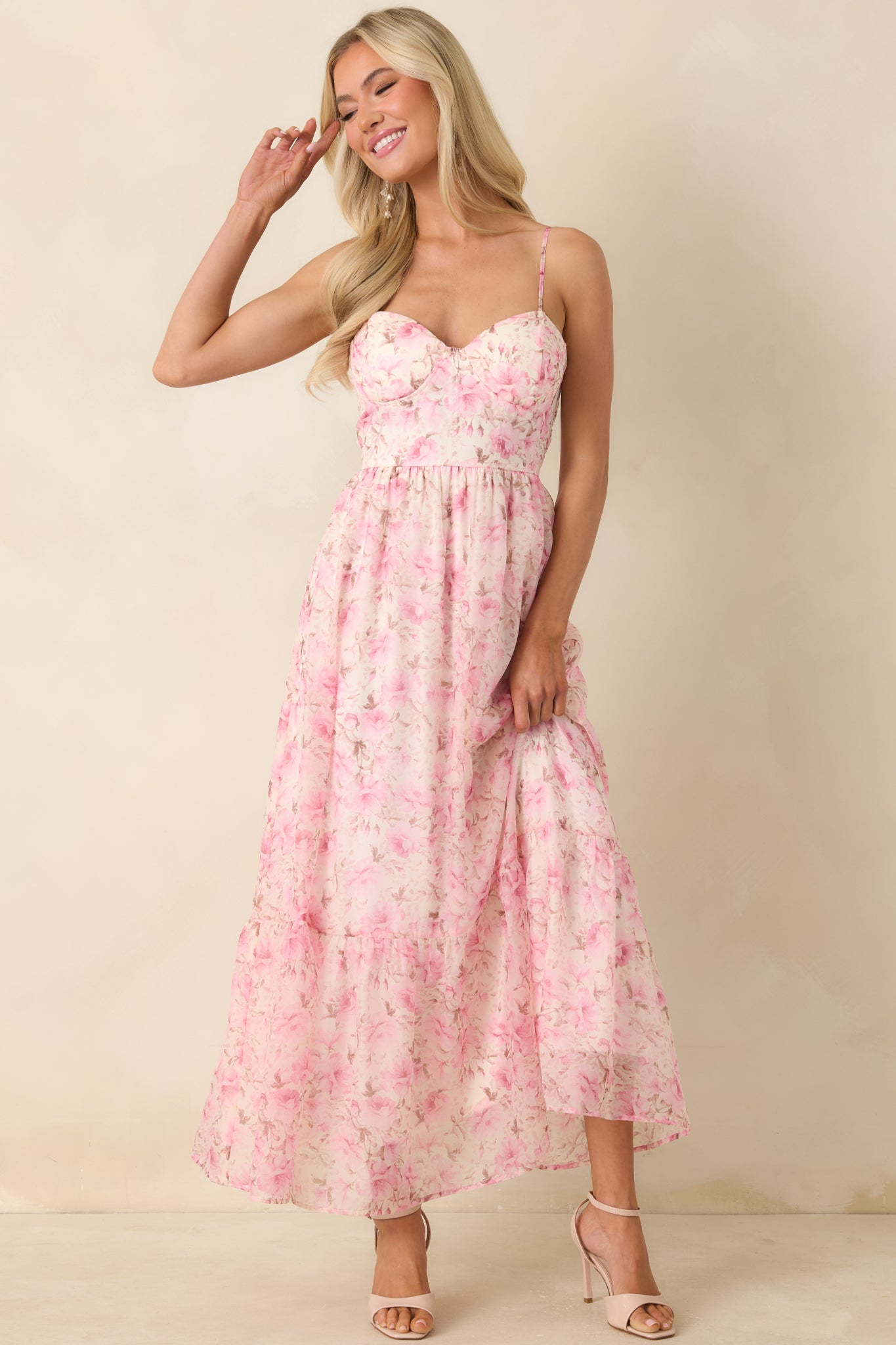 Pink multi floral midi dress featuring a bustier-style bodice, adjustable spaghetti straps, and a lightweight, flowy silhouette.