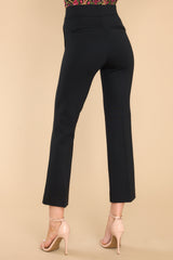 Back view of these pants that feature a pull-on design that hits the hipline and non functional pockets.