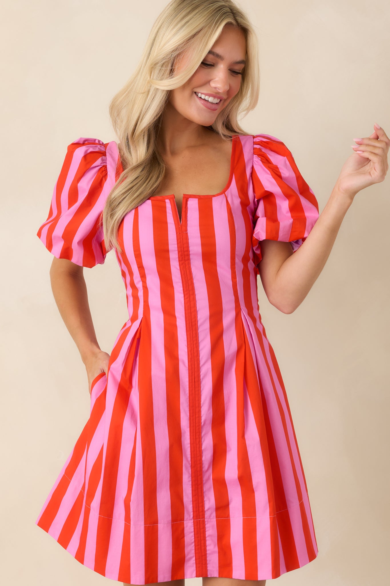 Mini dress featuring hidden side pockets and gently flared skirt movement.