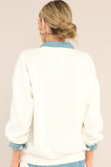 Back view of this sweatshirt that features a ribbed crew neckline, dropped shoulders, terry cloth wording, a ribbed hemline, and ribbed cuffed long sleeves.