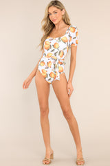 Full body view of this swimsuit that features a square neckline, an open back, removable padding, a removable self-tie belt, and elastic cuffed short sleeves.