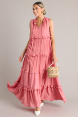 Front view of this dress that features a ruffled v-neckline with a self-tie closure, a sleeveless design, and a flowy skirt with subtle ruffle detailing throughout.