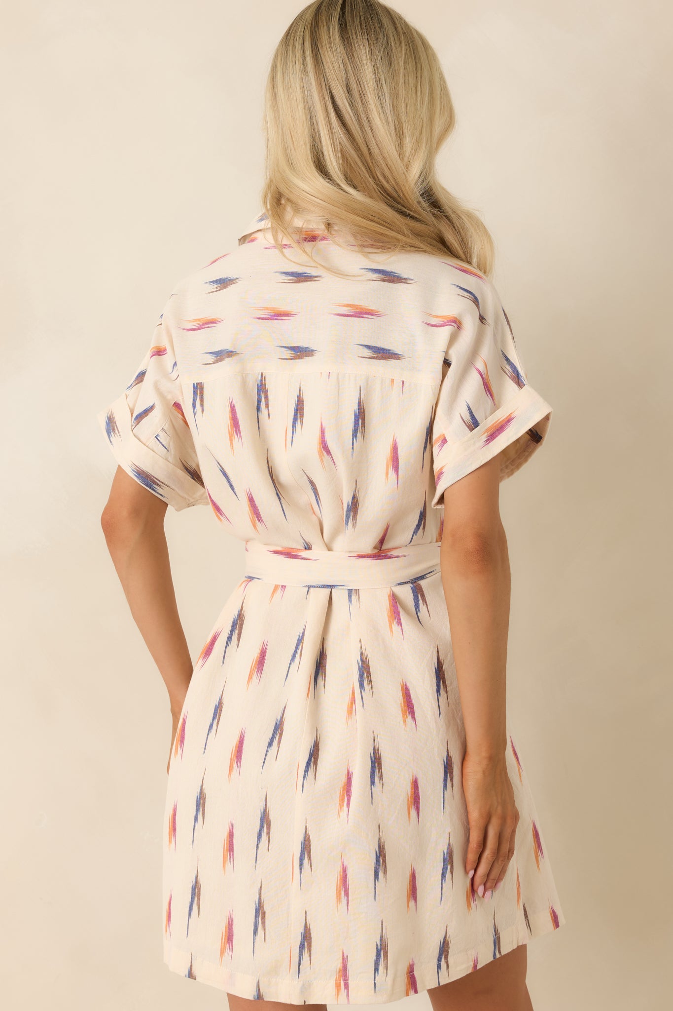 Rear view of the cream multi print shirt dress featuring a collared neckline, relaxed silhouette, and lightweight cotton construction.