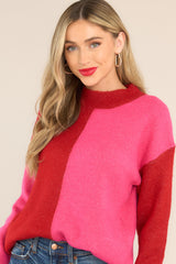Front view of this sweater that features a high neckline, a two toned color pattern, and cuffed long sleeves.