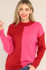 Front view of this sweater that features a two toned color pattern of red and pink.