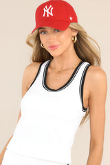 Front view of this tank top that features a scoop neckline, removable pads in the bust, an elastic band below the bust for support, and a cropped length.