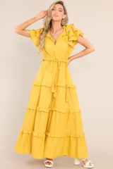 Full body view of  this dress that features a v-neckline with a self-tie closure, ruffled flutter sleeves, a drawstring waistband, and a long, flowy skirt.