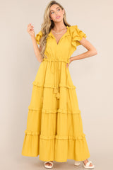Front view of  this dress that features a v-neckline with a self-tie closure, ruffled flutter sleeves, a drawstring waistband, and a long, flowy skirt.