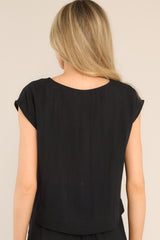 Back view of this top that features a cap sleeve design, a crew neckline, slightly cropped length, and breezy lightweight fabric.