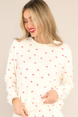 Front view of this top that features a ribbed crew neckline, an all-over festive print, cuffed long sleeves, and a cuffed hemline.