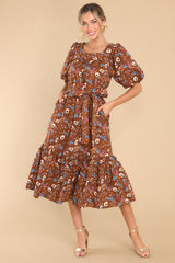 Full body view of this dress that showcases a floral print of the brown fabric.