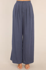Front view of these pants that feature a high waisted design, a hook and bar closure with zipper, and a wide leg.