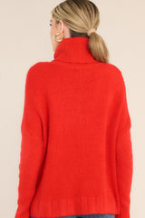 Back view of red turtleneck sweater that features dropped shoulders and a cowl-like neckline. 