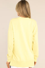Back view of this weekender that features a v-neckline, dropped shoulders, ribbed cuffed sleeves, and a split ribbed hemline.