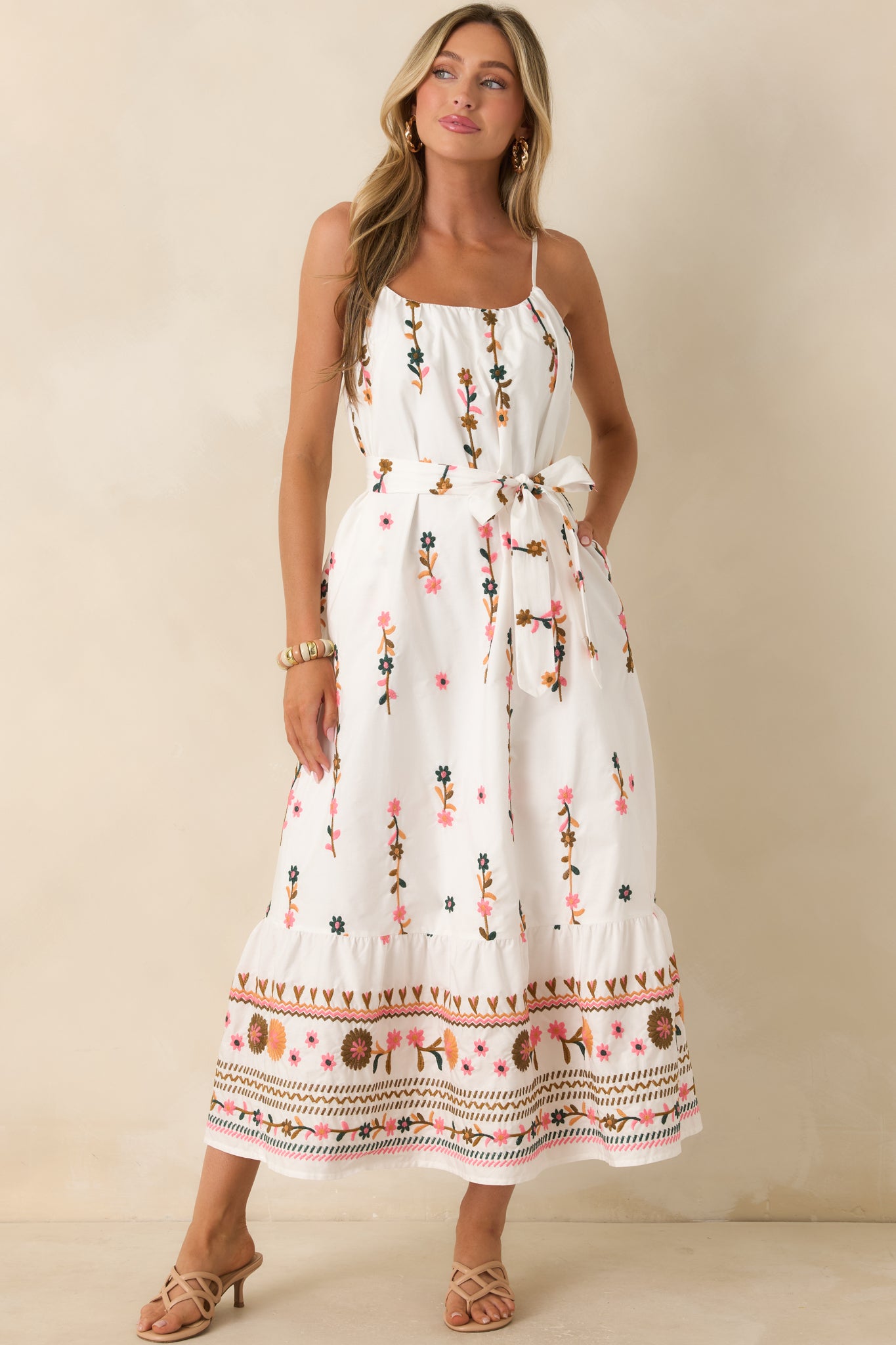 Embroidered ivory maxi dress featuring statement border detailing and a relaxed, breezy fit.